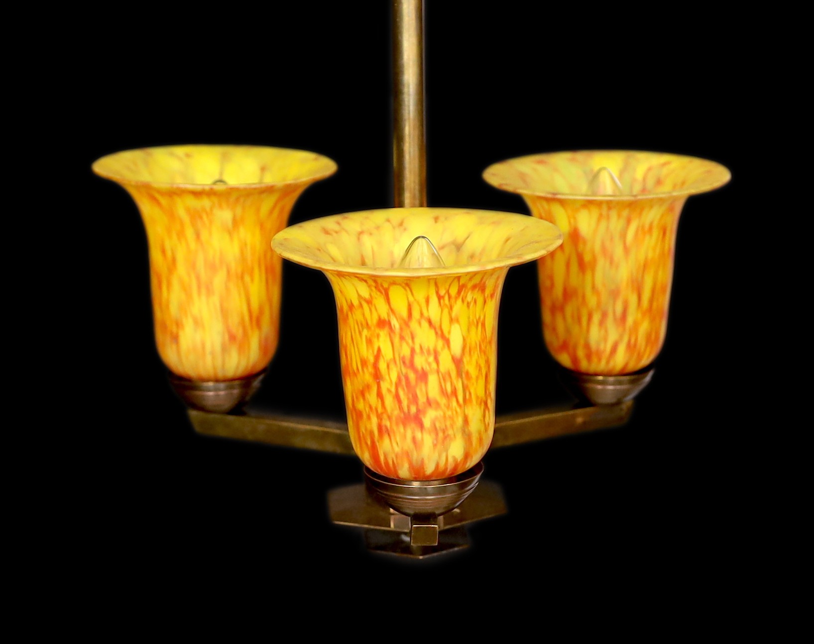 A 1930s GLC bronzed metal light fitting with three marbled amber glass shades, height 60cm. width 33cm